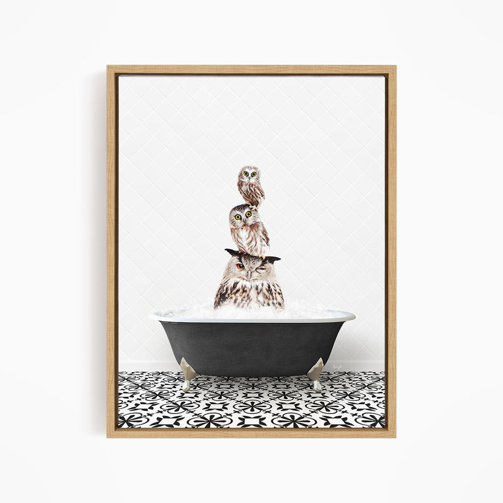 A framed image depicting a group of owls sitting in a bathtub filled with water, creating a whimsical and playful scene.