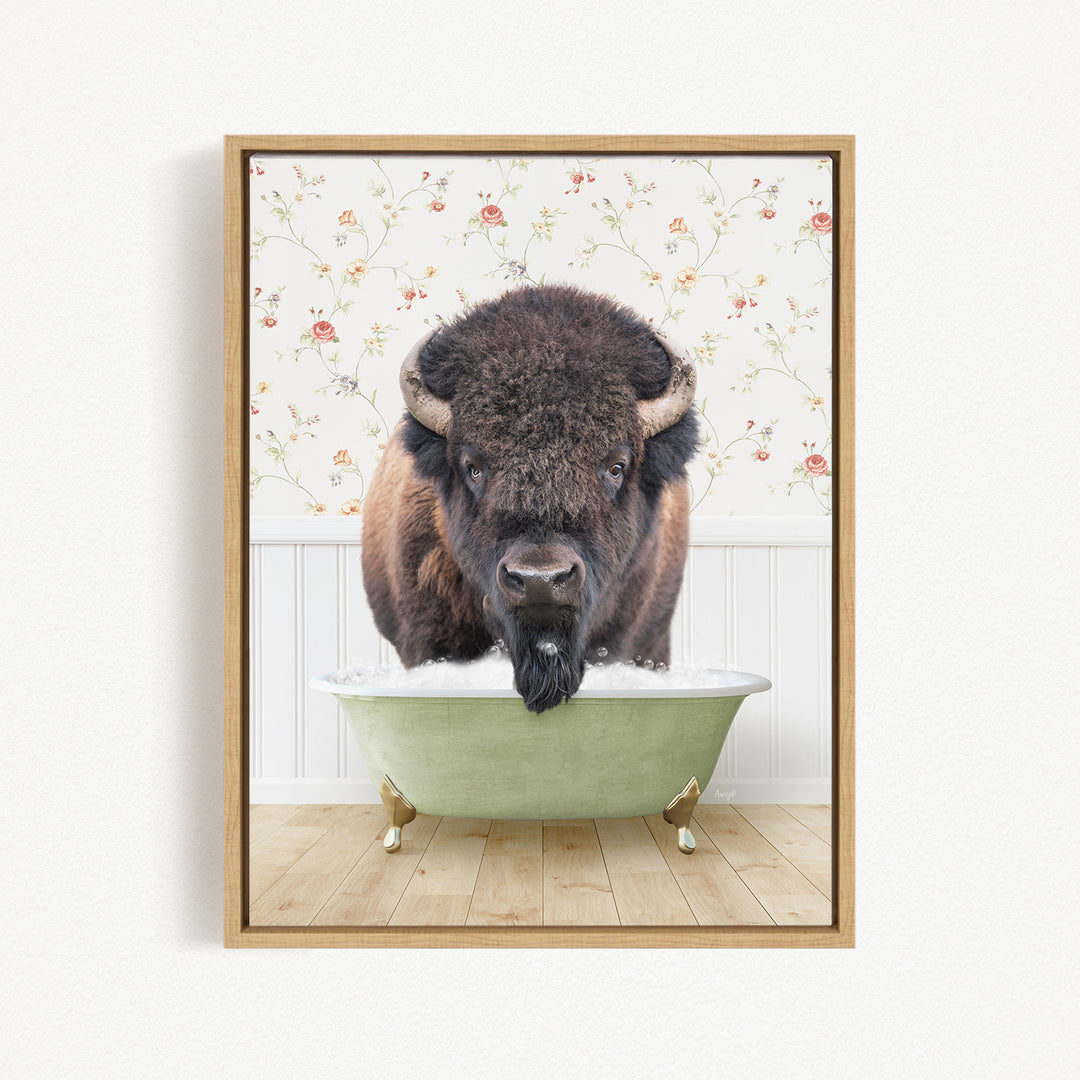 A buffalo with a long beard is sitting in a green bathtub, with a floral wallpaper in the background.