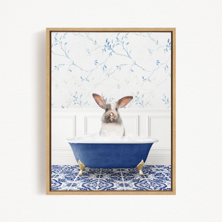 A white and brown rabbit sitting in a blue bathtub filled with water, with a blue and white patterned tile floor in the background.