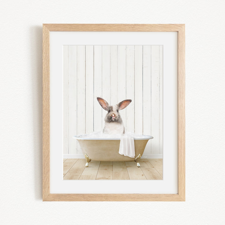 A small rabbit sitting in a bathtub filled with water, with its head poking out of the tub.