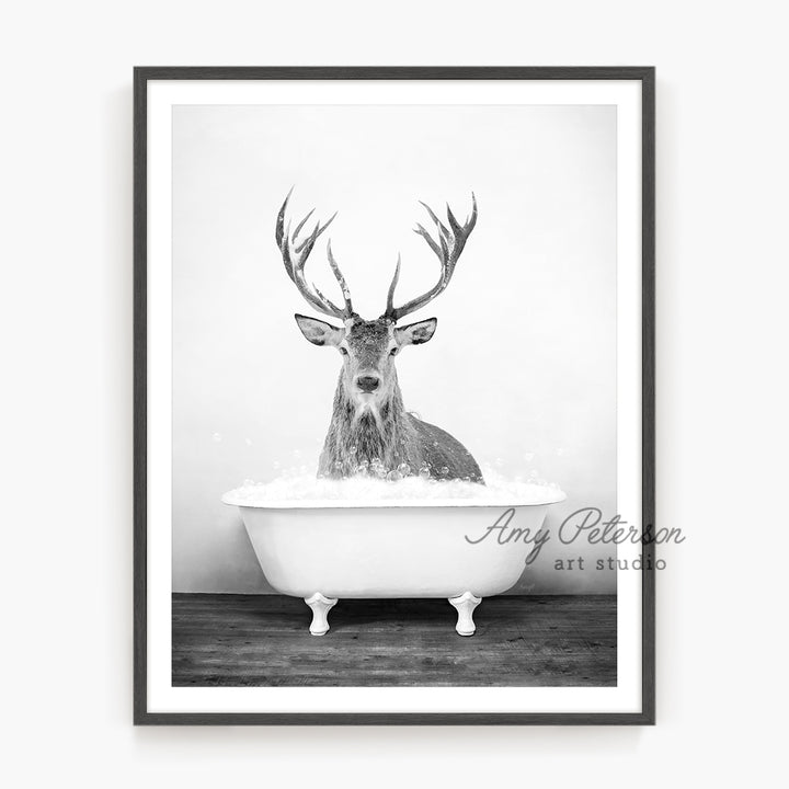 a black and white photo of a deer in a bathtub