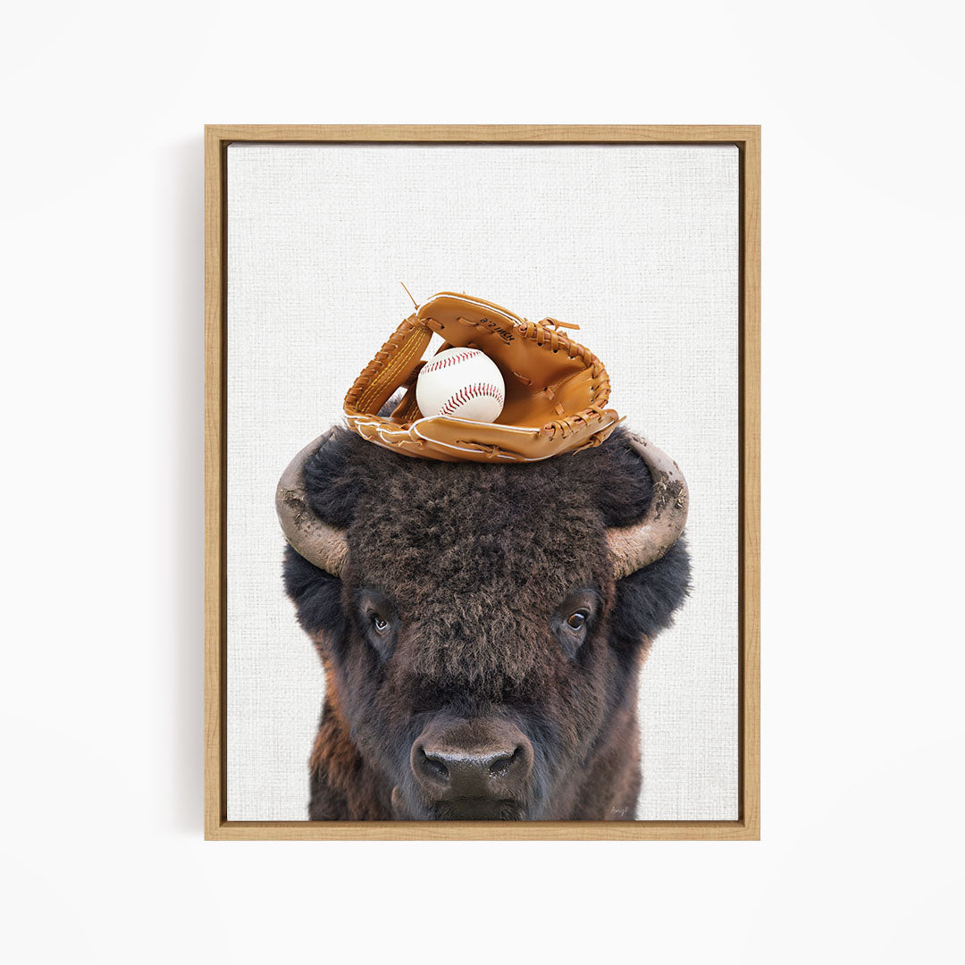 A buffalo with a baseball glove on its head.