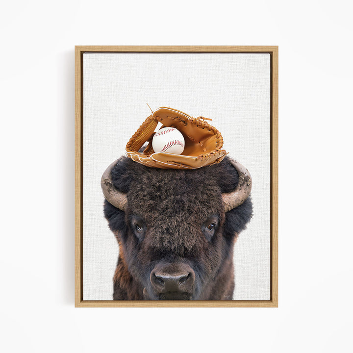 A buffalo with a baseball glove on its head.