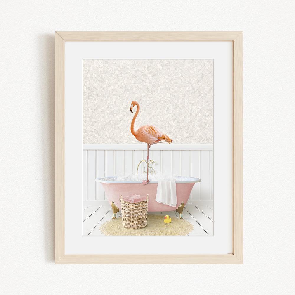 A pink bathtub with a flamingo standing on it, surrounded by a basket of toys and a yellow rubber duck.