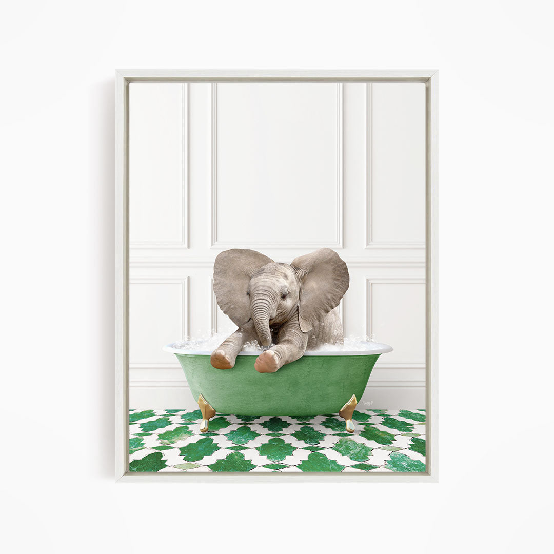 A baby elephant sitting in a green bathtub filled with water, surrounded by a green and white patterned floor.