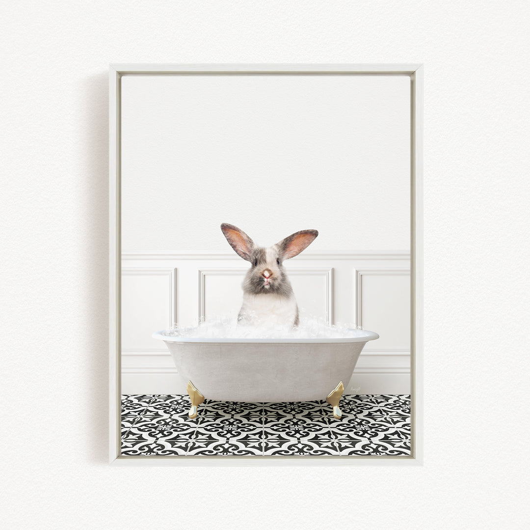 A white rabbit sitting in a white bathtub filled with water, with a black and white patterned floor in the background.