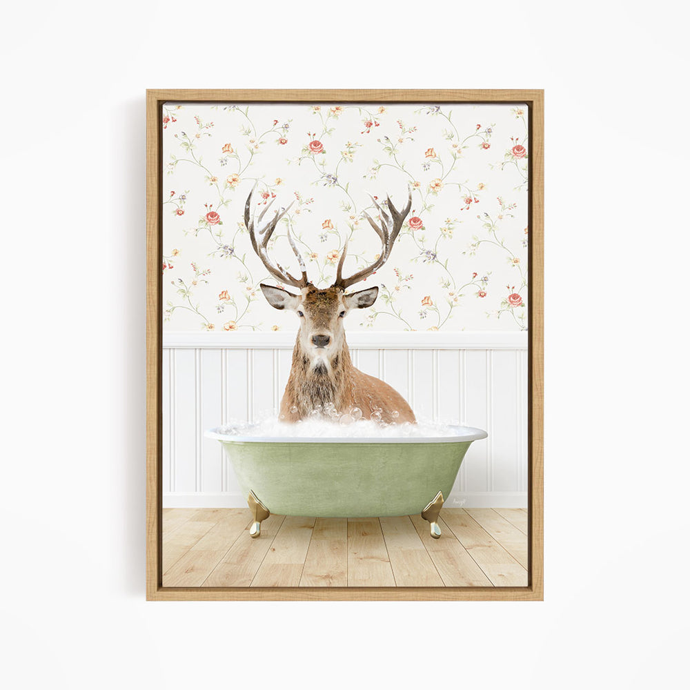 A deer with large antlers is sitting in a green bathtub, surrounded by a floral wallpaper.