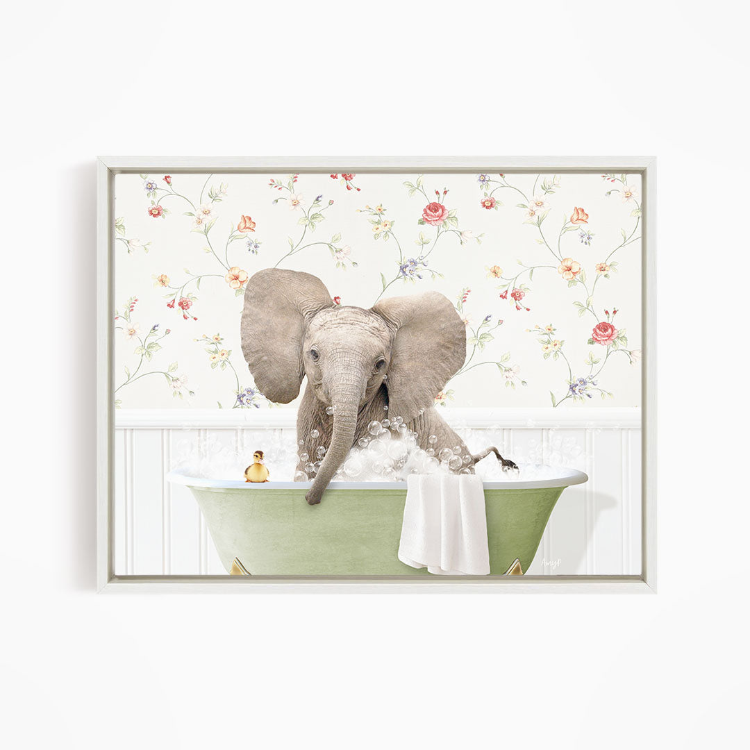 A gray elephant is sitting in a green bathtub filled with water, surrounded by a floral wallpaper.