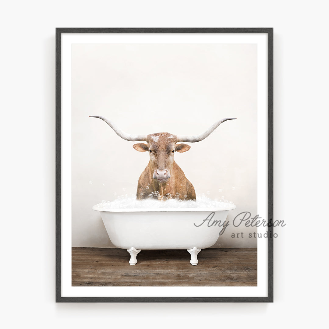 a long horn steer is taking a bath in a bathtub