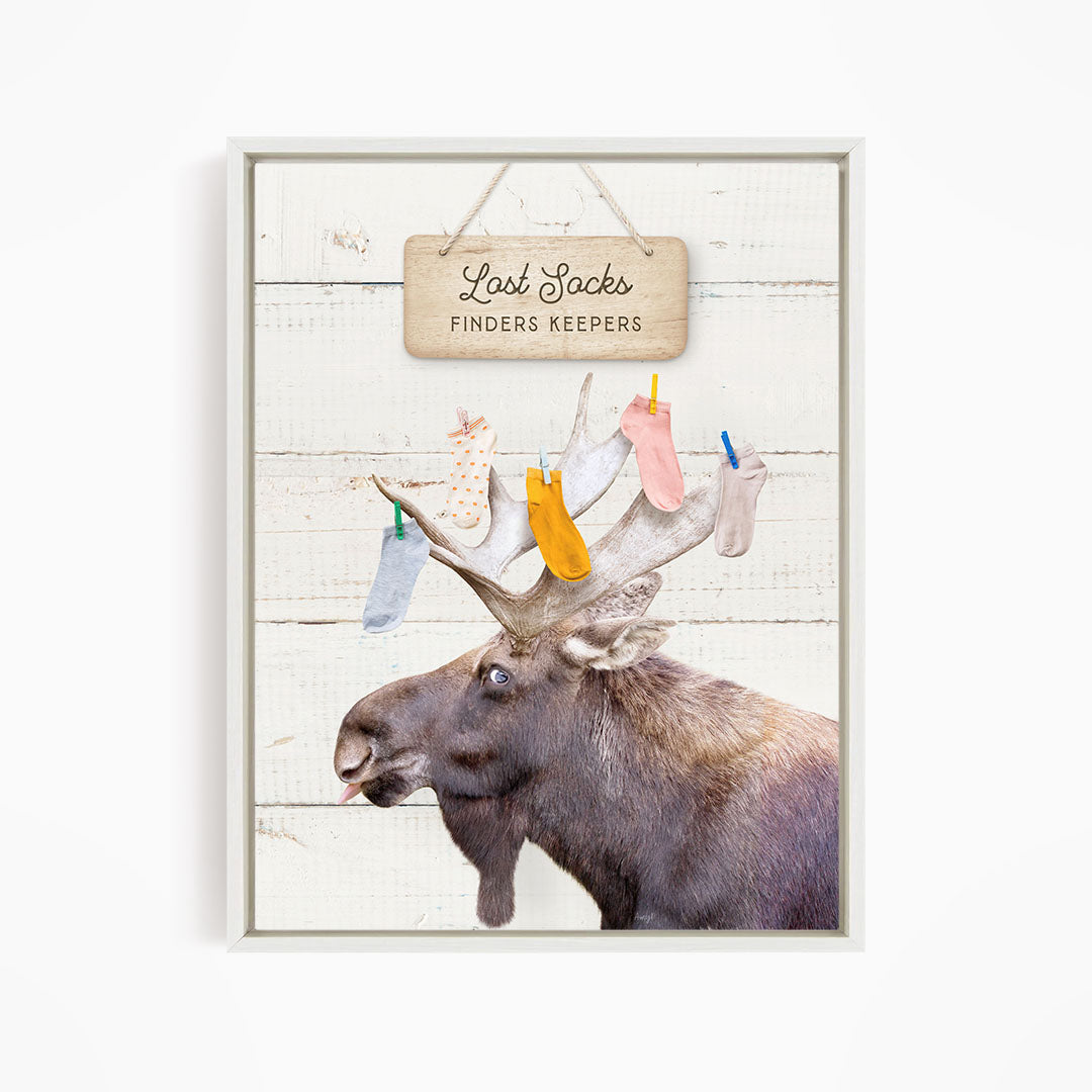 A moose with a sign that says "Lost Socks Finders Keepers" hanging above it.