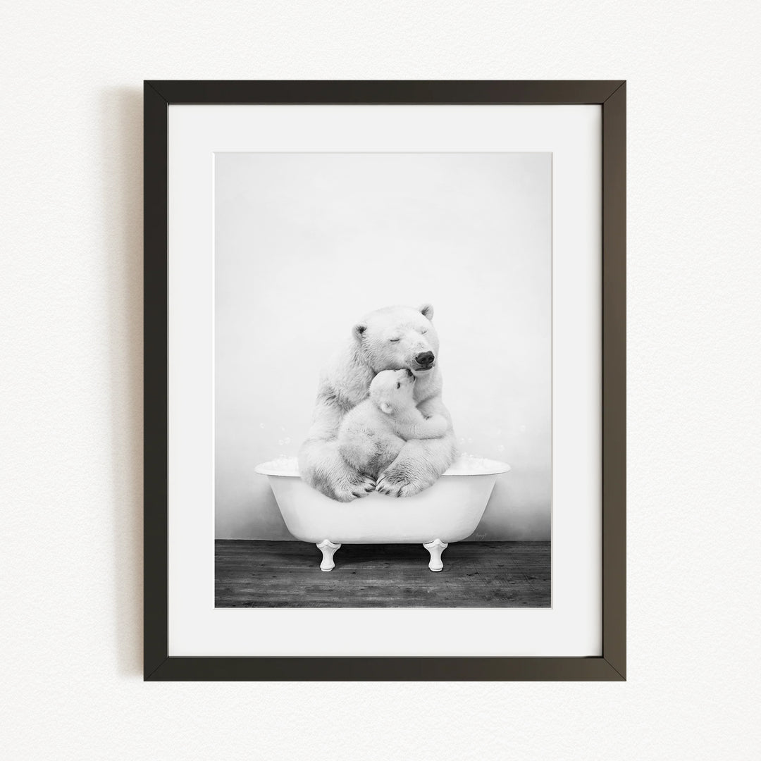 A black and white photograph of two polar bears sitting in a bathtub, with one bear appearing to be a mother bear comforting her cub.