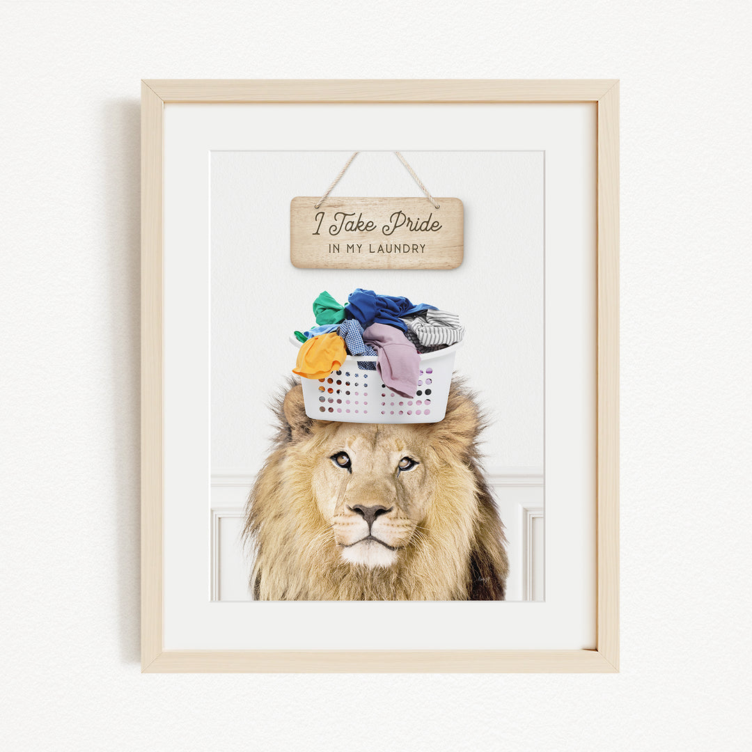 A framed image of a lion wearing a basket of laundry, with a sign above that says "I Take Pride in My Laundry".