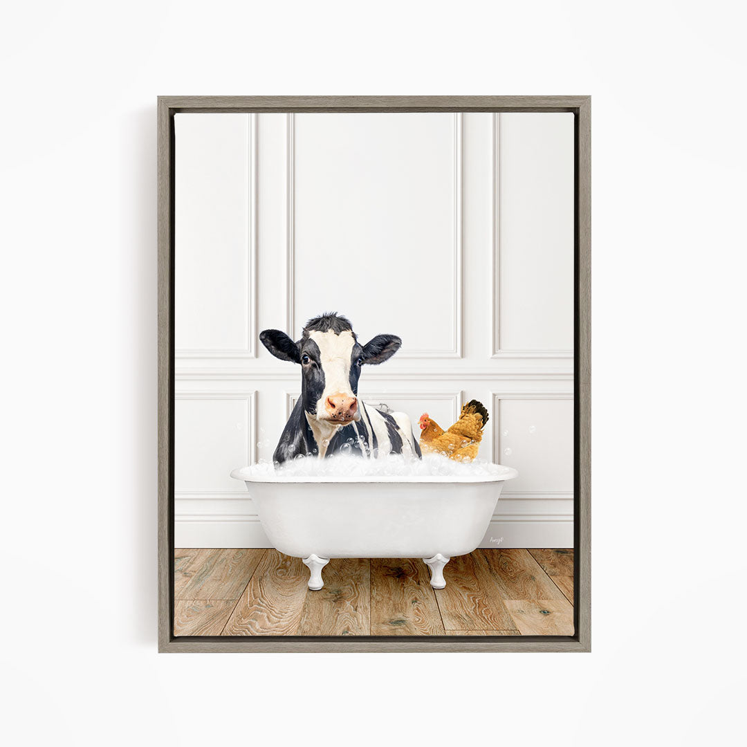 A black and white cow is sitting in a white bathtub, with a chicken nearby, in a white-walled room.