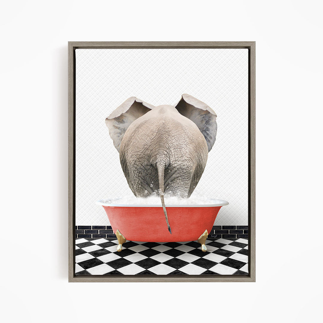 An elephant is sitting in a red bathtub filled with water, with its trunk submerged in the water.