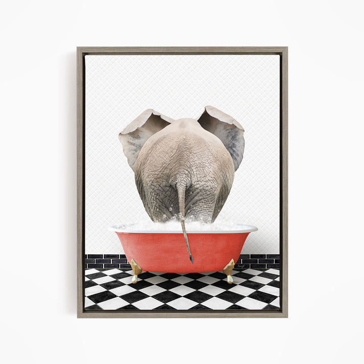An elephant is sitting in a red bathtub filled with water, with its trunk submerged in the water.