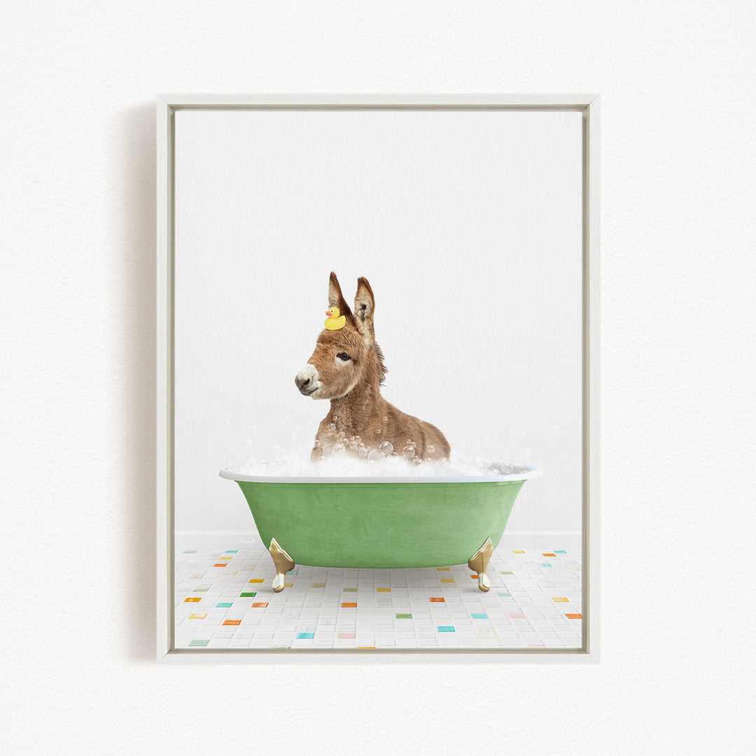 A donkey is sitting in a green bathtub filled with bubbles, with a yellow rubber duck floating on its head.