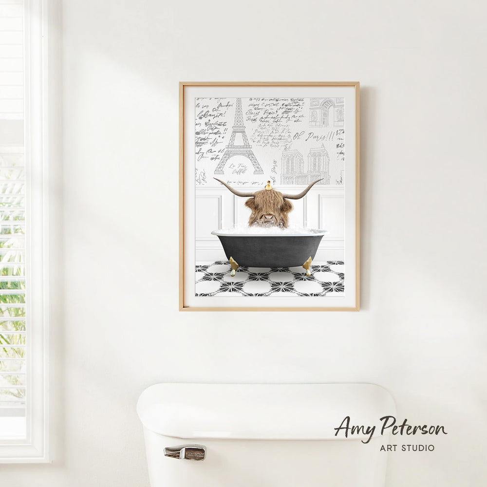a framed illustration of a cow sitting in a bathtub, surrounded by various architectural drawings and text.