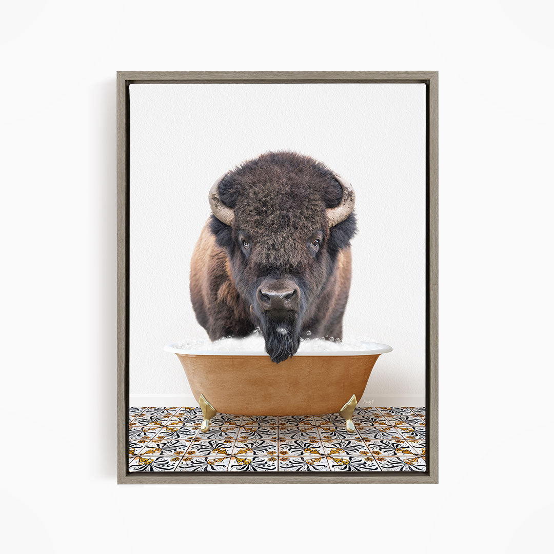 A buffalo with large horns is standing in a large bowl of water, with a patterned tile floor beneath it.