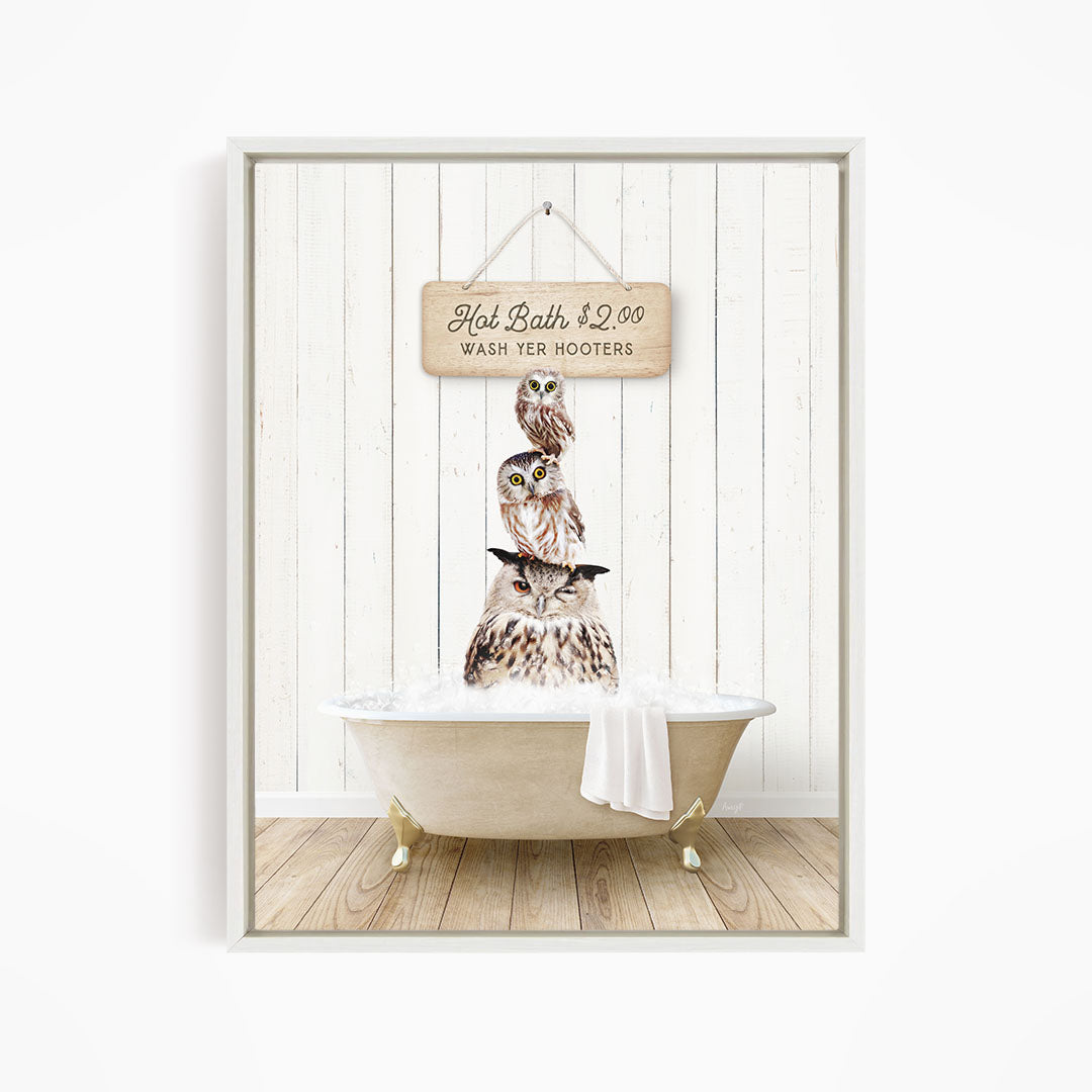A framed image depicting a wooden sign with the text "Hot Bath $2.00 WASH YER HOOKERS" and a wooden bathtub with a cat sitting in it.