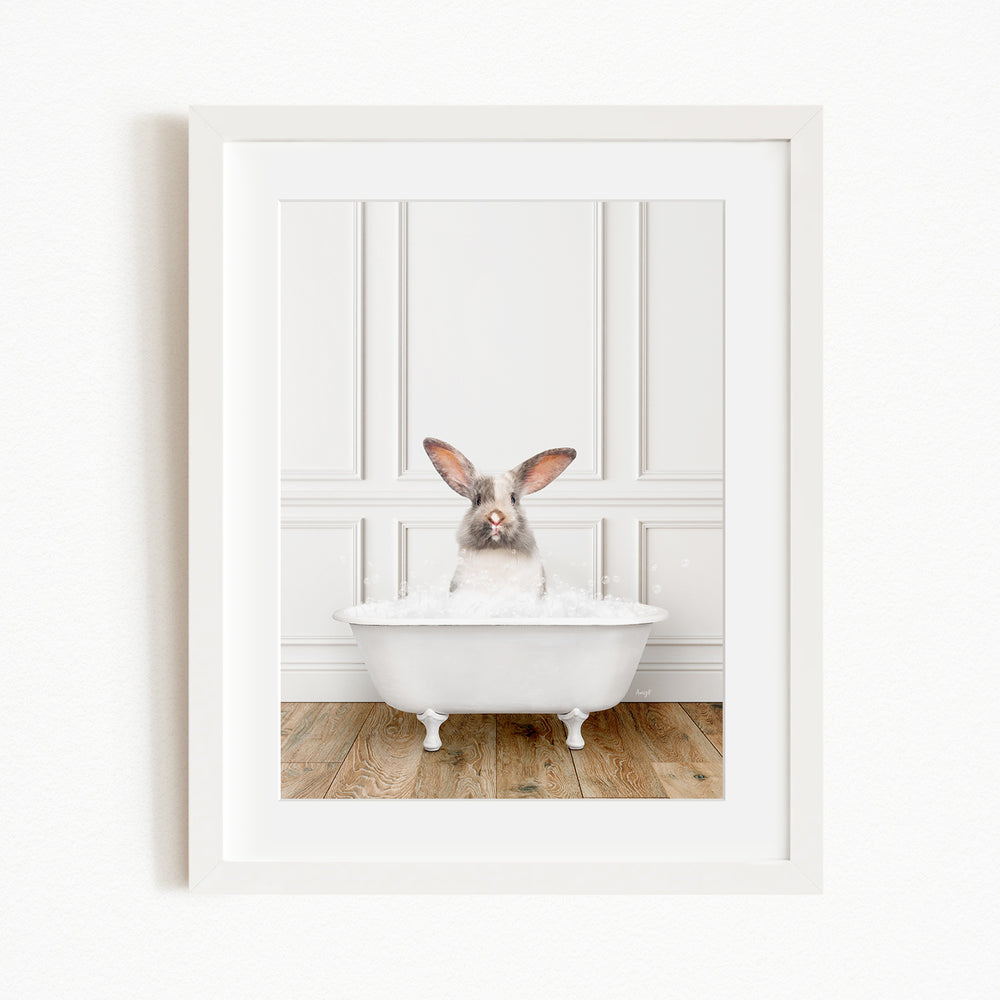 A white rabbit sitting in a white bathtub filled with water, with its head raised and looking directly at the camera.