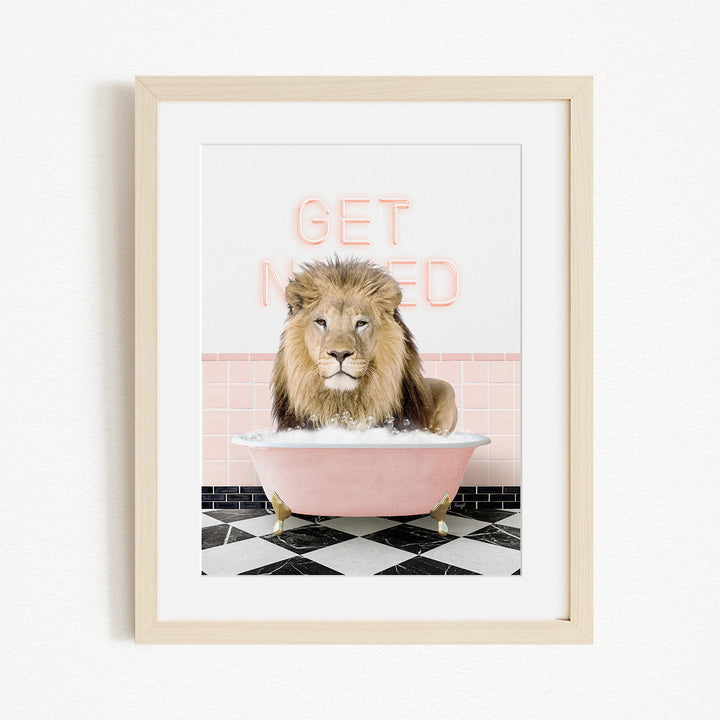 A lion sitting in a pink bathtub with the words "GET NICKED" written on the wall behind it.