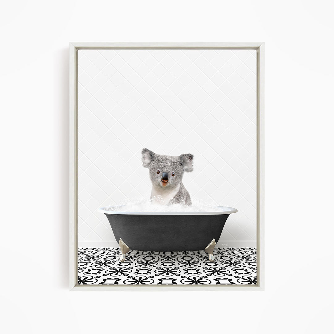 A koala bear sitting in a bathtub filled with water, surrounded by a black and white patterned floor.