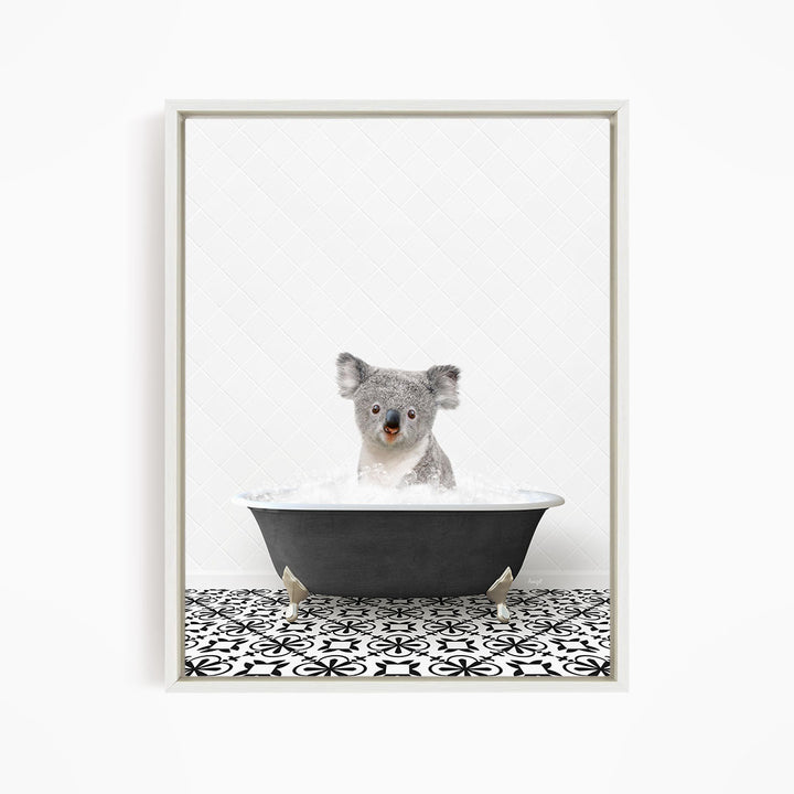 A koala bear sitting in a bathtub filled with water, surrounded by a black and white patterned floor.