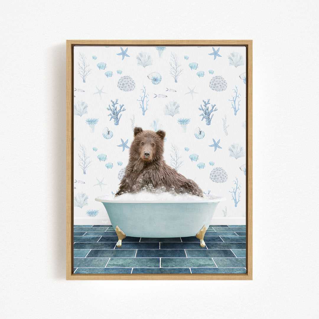 A brown bear sitting in a bathtub filled with bubbles, surrounded by a blue and white ocean-themed wallpaper.