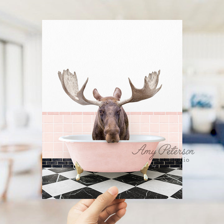 a person holding up a card with a picture of a moose in a bathtub