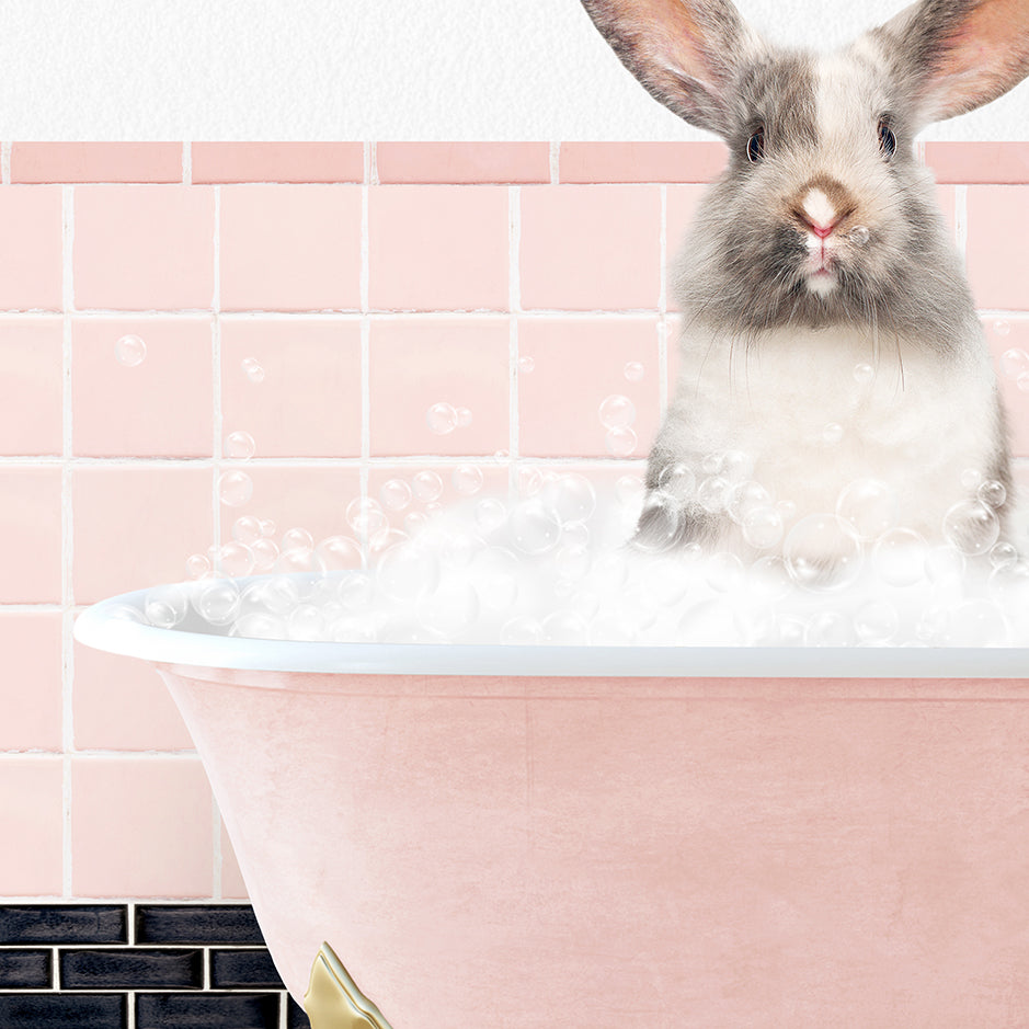 a rabbit sitting inside of a bath tub filled with bubbles