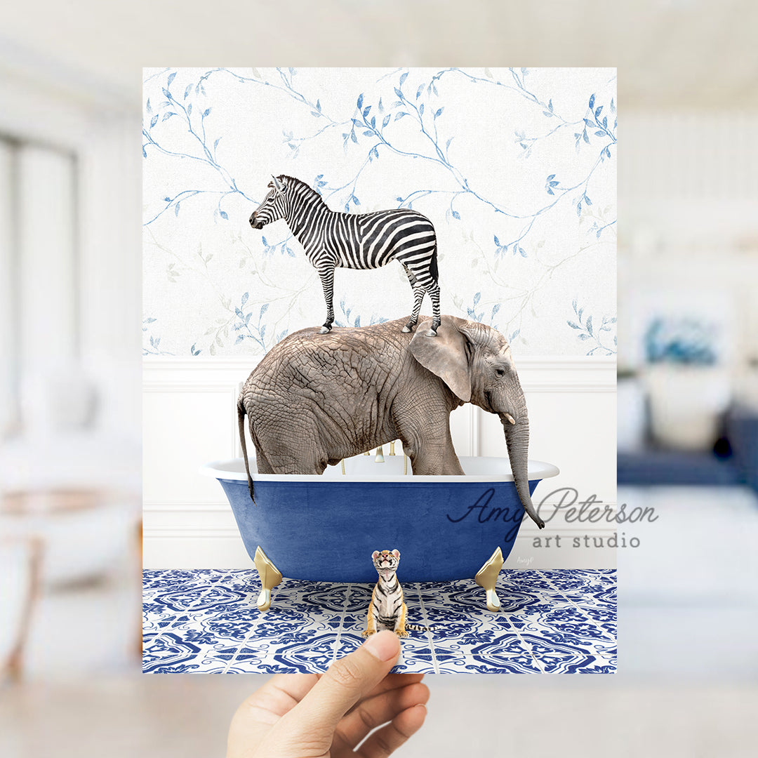 a person holding a card with a picture of a zebra and an elephant in a