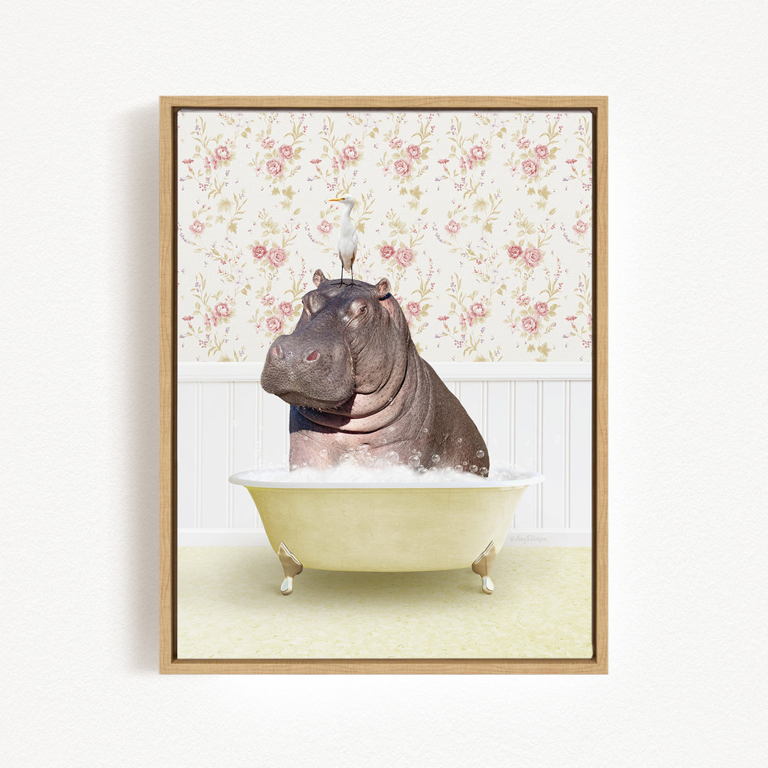 A framed image depicting a hippopotamus sitting in a bathtub filled with bubbles, with a bird perched on its head.