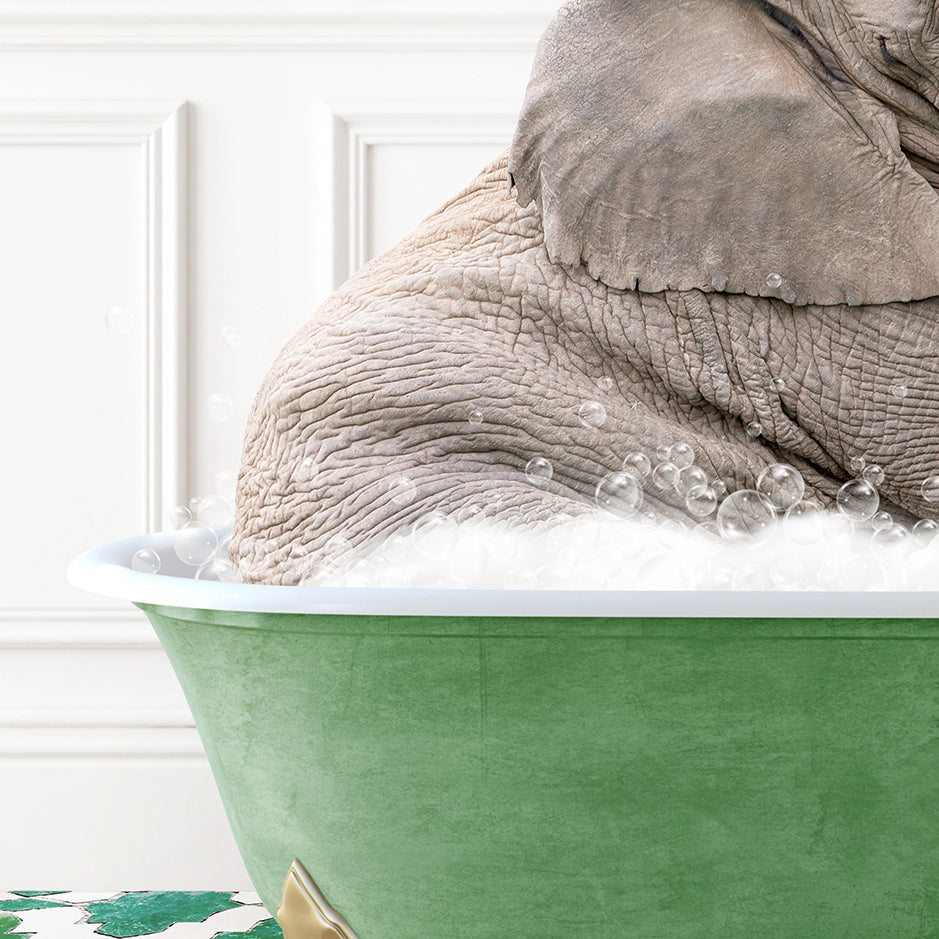 an elephant is taking a bath in a green tub