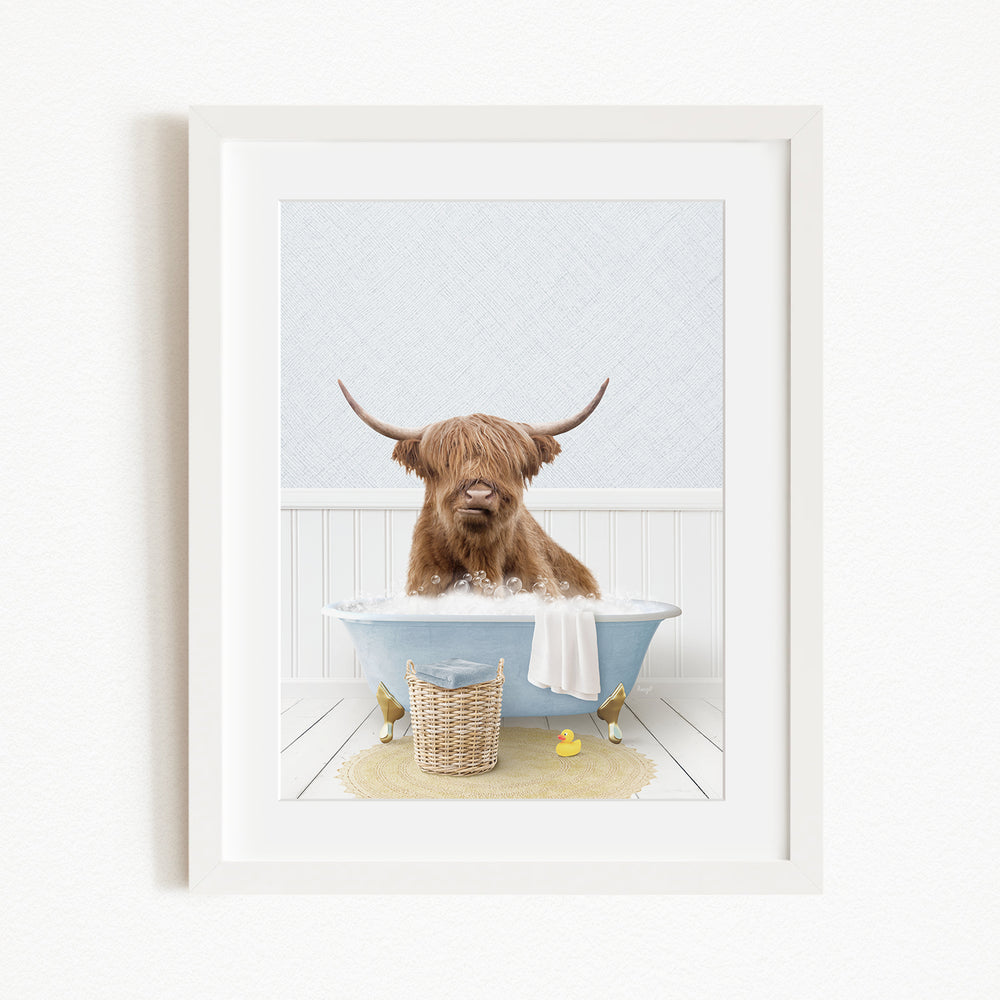 A brown Highland cow with large horns is sitting in a blue bathtub filled with water, surrounded by rubber ducks and a basket.