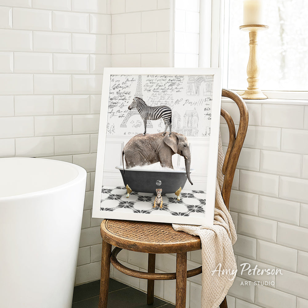 A framed image depicting a zebra standing on an elephant in a bathtub, with a towel draped over the back of a wooden chair in a bathroom setting.