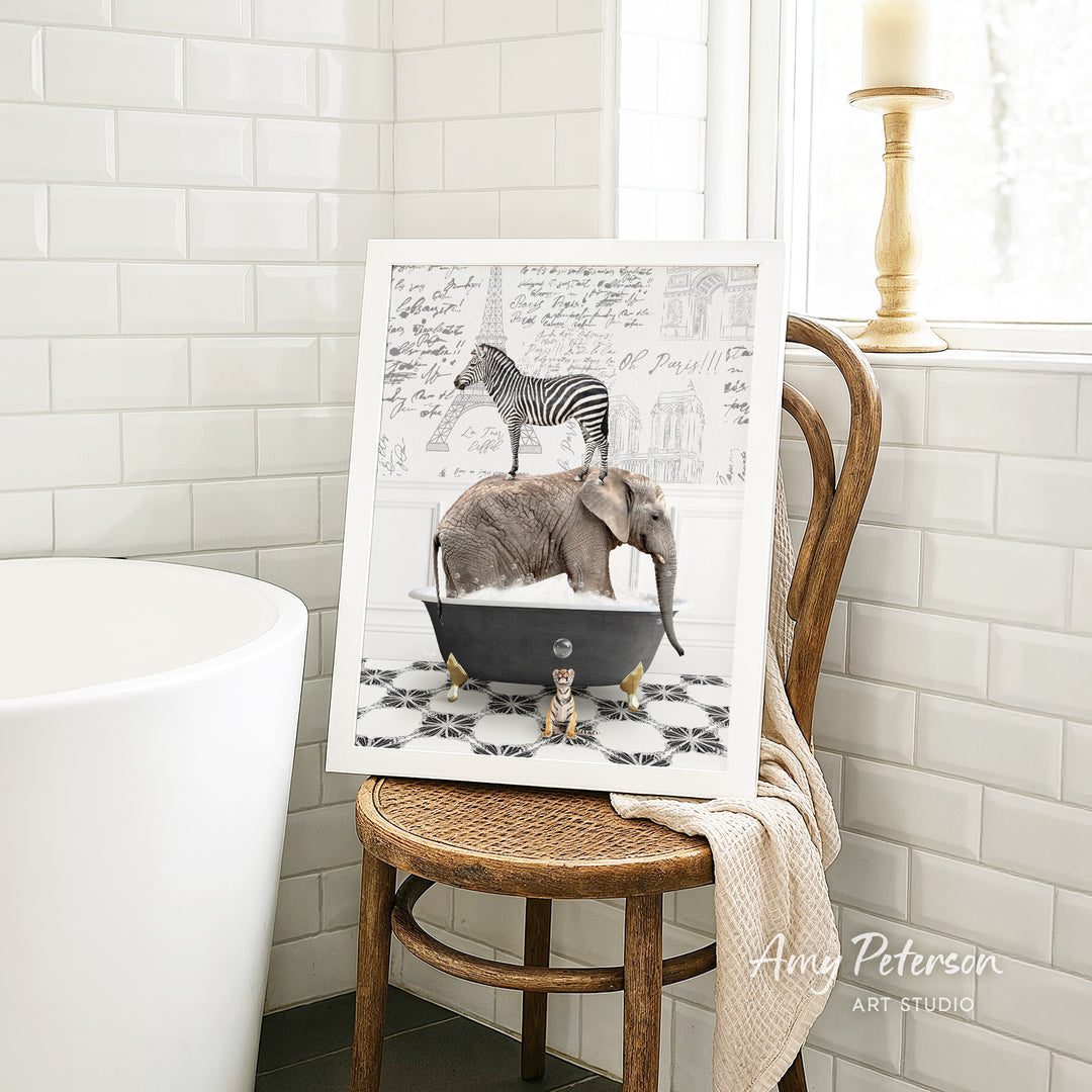 A framed image depicting a zebra standing on an elephant in a bathtub, with a towel draped over the back of a wooden chair in a bathroom setting.
