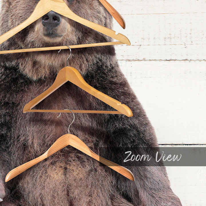 A close-up of a bear's head and neck, with several wooden hangers hanging from its mouth and neck.