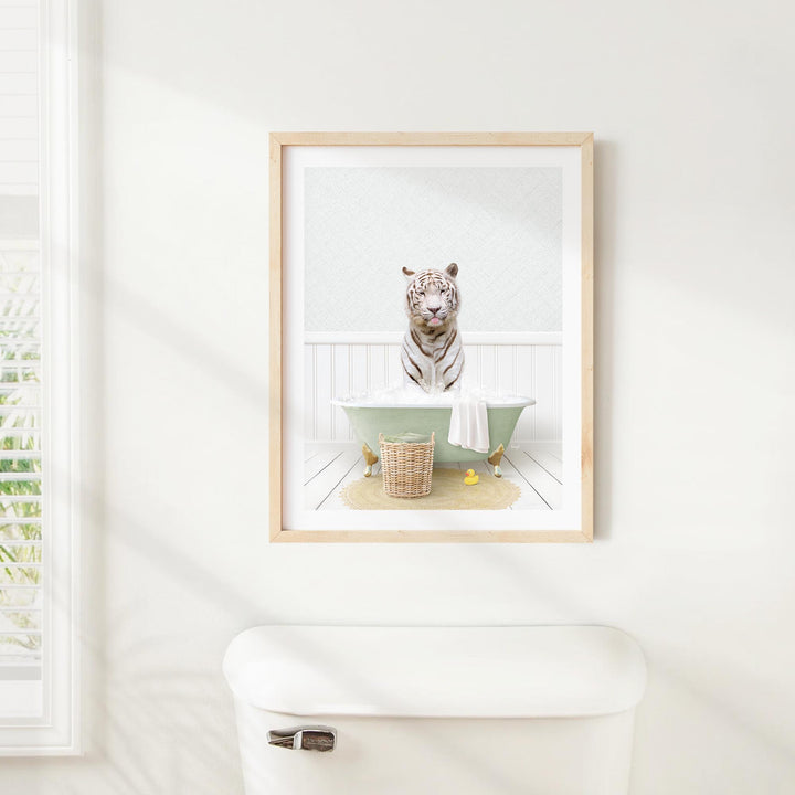 A framed image of a tiger sitting in a bathtub, surrounded by various objects such as a basket and a towel.