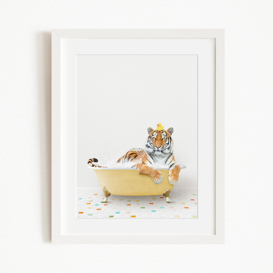 A tiger is sitting in a yellow bathtub filled with bubbles, with a yellow rubber duck perched on its head.