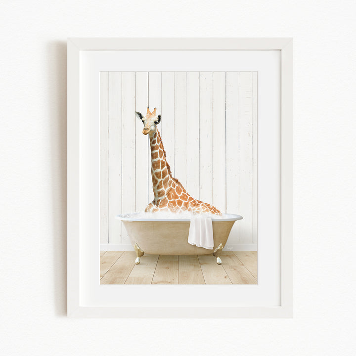 A giraffe sitting in a bathtub filled with water, with a white wooden wall in the background.