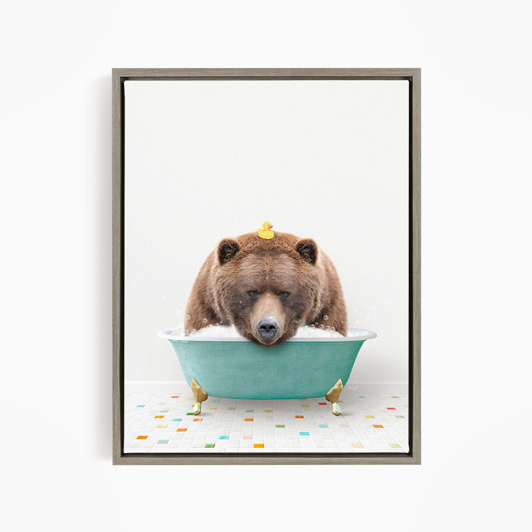 A brown bear is sitting in a green bathtub, with a yellow rubber duck perched on its head.