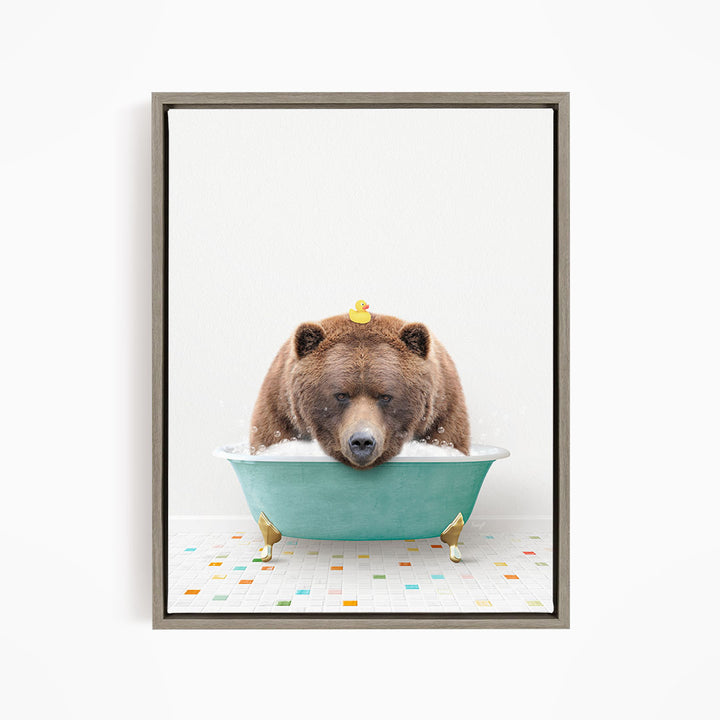 A brown bear is sitting in a green bathtub, with a yellow rubber duck perched on its head.