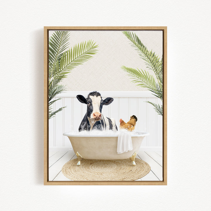A black and white cow is sitting in a bathtub filled with water, surrounded by palm leaves and a chicken.