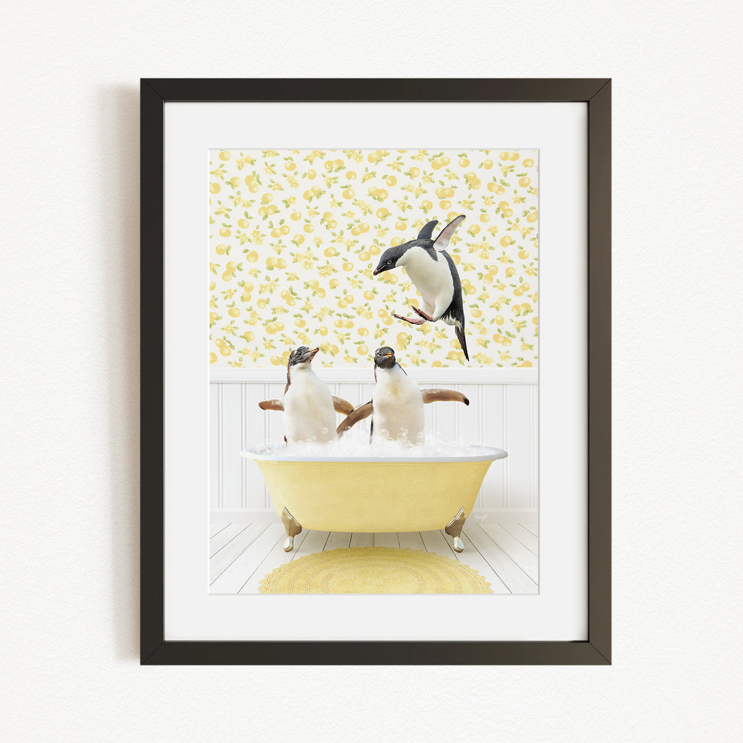 A framed image depicting two penguins sitting in a yellow bathtub, with one penguin standing on the edge of the tub and another penguin sitting inside the tub.