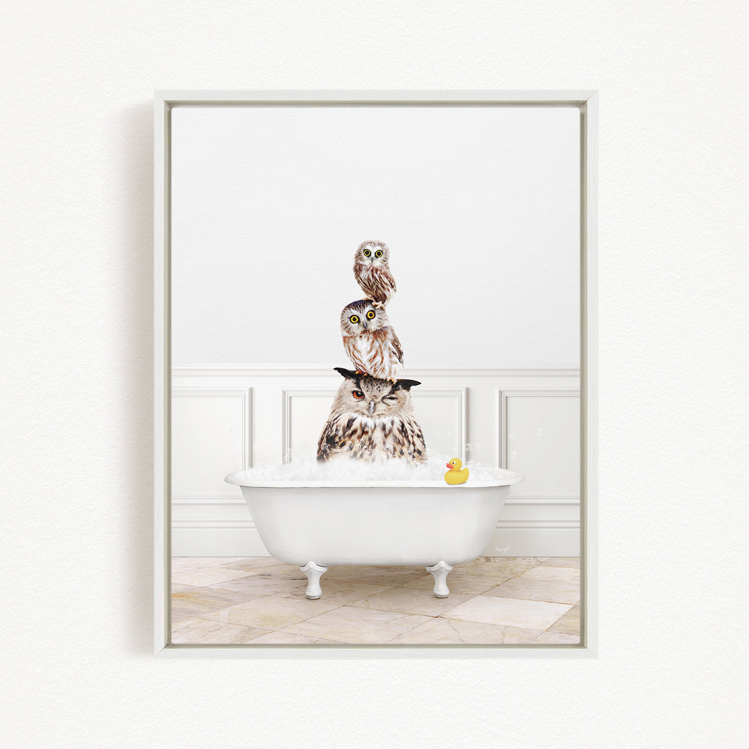 A white bathtub filled with water, with three owls sitting on top of it. One of the owls has a yellow rubber duck floating in the water.