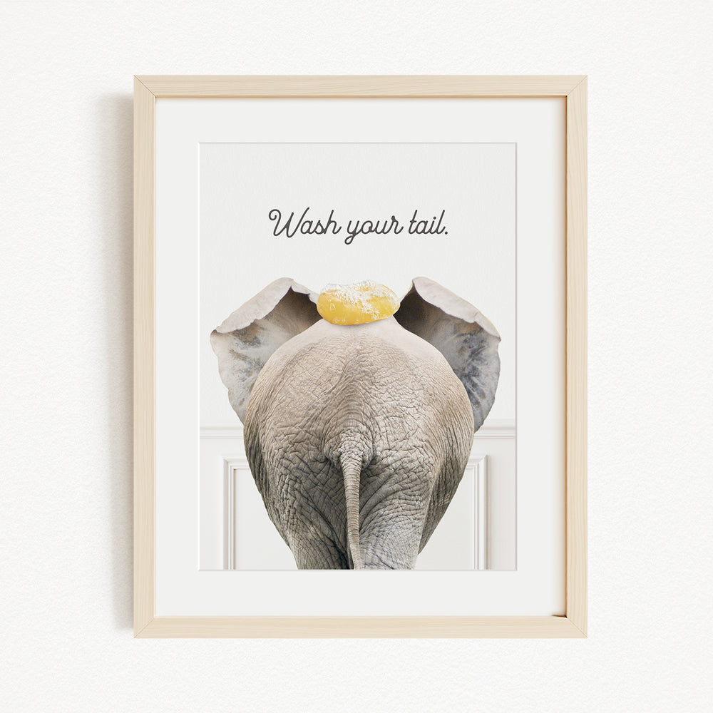 an elephant with a yellow object on its head, accompanied by the text "Wash your tail."