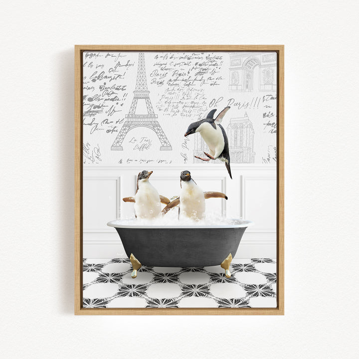 A framed image depicting two penguins sitting in a bathtub, with one penguin flying towards the other. The background features the Eiffel Tower and other architectural elements.