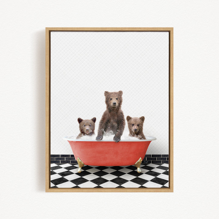 A framed image depicting three brown bears sitting in a red bathtub on a black and white checkered floor.