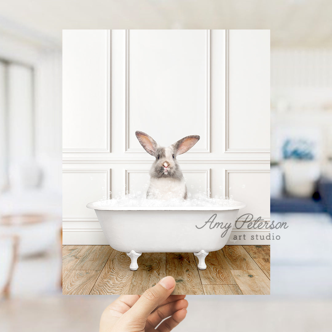 a person holding a photo of a rabbit in a bathtub