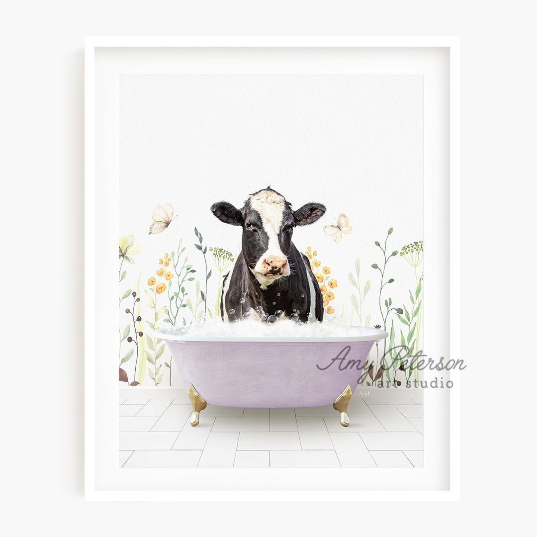 a black and white cow sitting in a bathtub